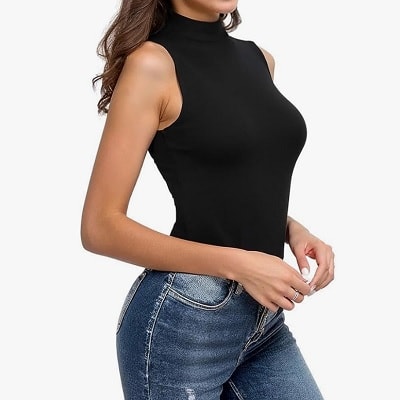 A woman wearing a black bodysuit and blue jeans