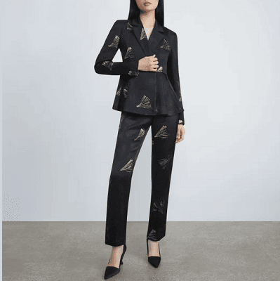 woman in black jacquard suit with leaf print details on it