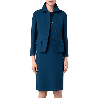 woman wears tealish blue dress with matching blazer; blazer has a collar, pockets, and buttons to the neck