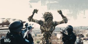 Two soldiers pointing their guns at an alien in District 9