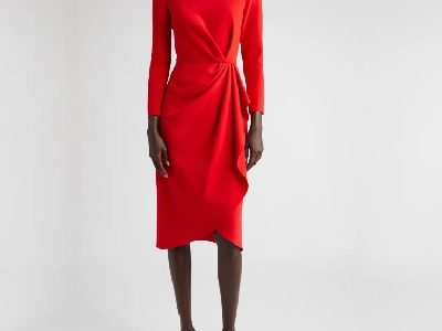 A woman wearing a red long sleeve midi dress and red high heels sandals
