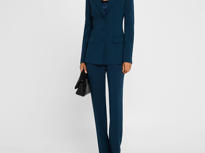 polished executive wears dark teal suit
