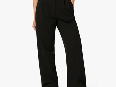 A woman wearing black pants, white sneakers, and white top