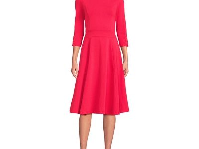 A woman wearing a light pink 3/4 sleeve dress and brown flat sandals