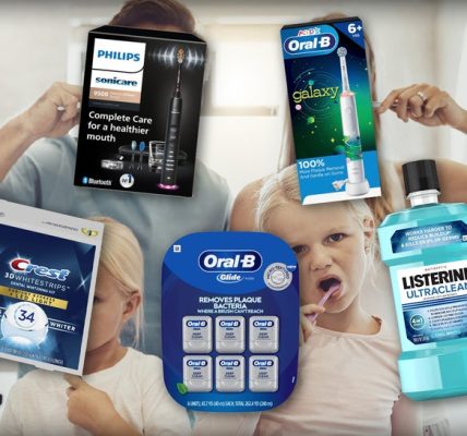 Family Brushing Their Teeth Surrounded By Oral Healthcare Products