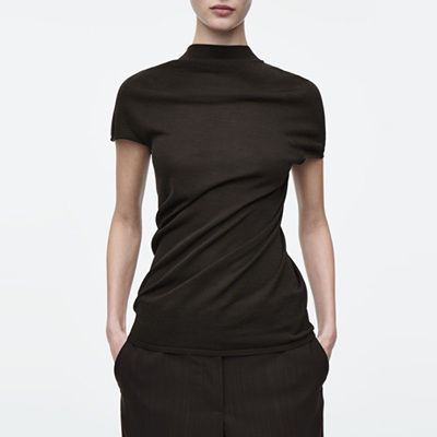 A woman wearing a black short-sleeved top and black pants