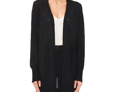 A woman wearing a white top with black long cardigan jacket and black pants