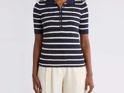 A woman wearing a blue white stripe polo shirt and white pants
