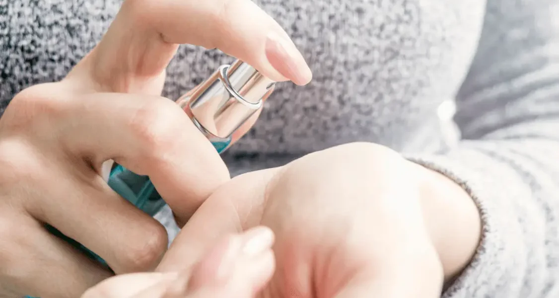 Woman hands holding perfume