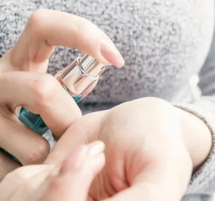 Woman hands holding perfume