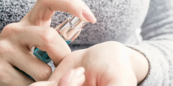 Woman hands holding perfume