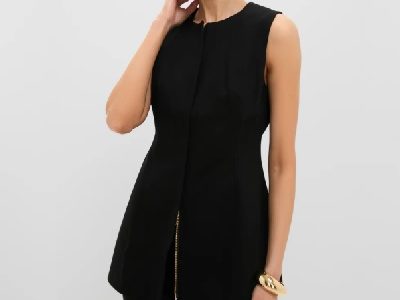 A woman wearing a black sleeveless top