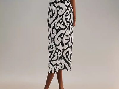 A woman wearing a black and white printed pencil skirt with black sandals