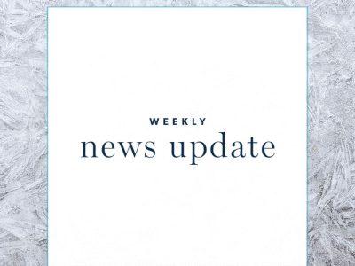 a white square with text "weekly news update," surrounded by a border of frost