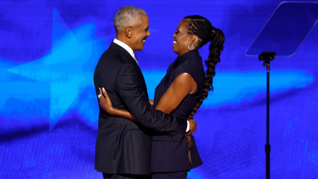 CHICAGO, ILLINOIS - AUGUST 20: Former U.S. President Barack Obama (L) greets former first lady Michelle Obama as he arrives to speak on stage during the second day of the Democratic National Convention at the United Center on August 20, 2024 in Chicago, Illinois. Delegates, politicians, and Democratic Party supporters are gathering in Chicago, as current Vice President Kamala Harris is named her party's presidential nominee. The DNC takes place from August 19-22. (Photo by Chip Somodevilla/Getty Images)