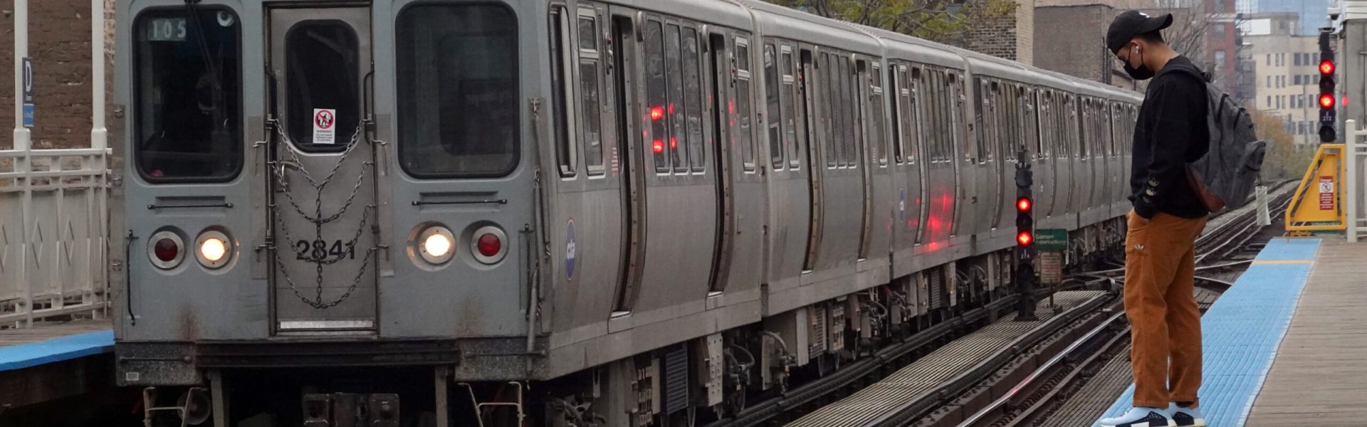 Passengers wait to board an "L" train at a station on November 09, 2021 in Chicago, Illinois.