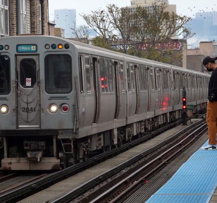 Passengers wait to board an "L" train at a station on November 09, 2021 in Chicago, Illinois.