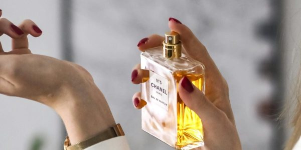 Close-up of a woman applying perfume on her wrist. Elegant and sophisticated.