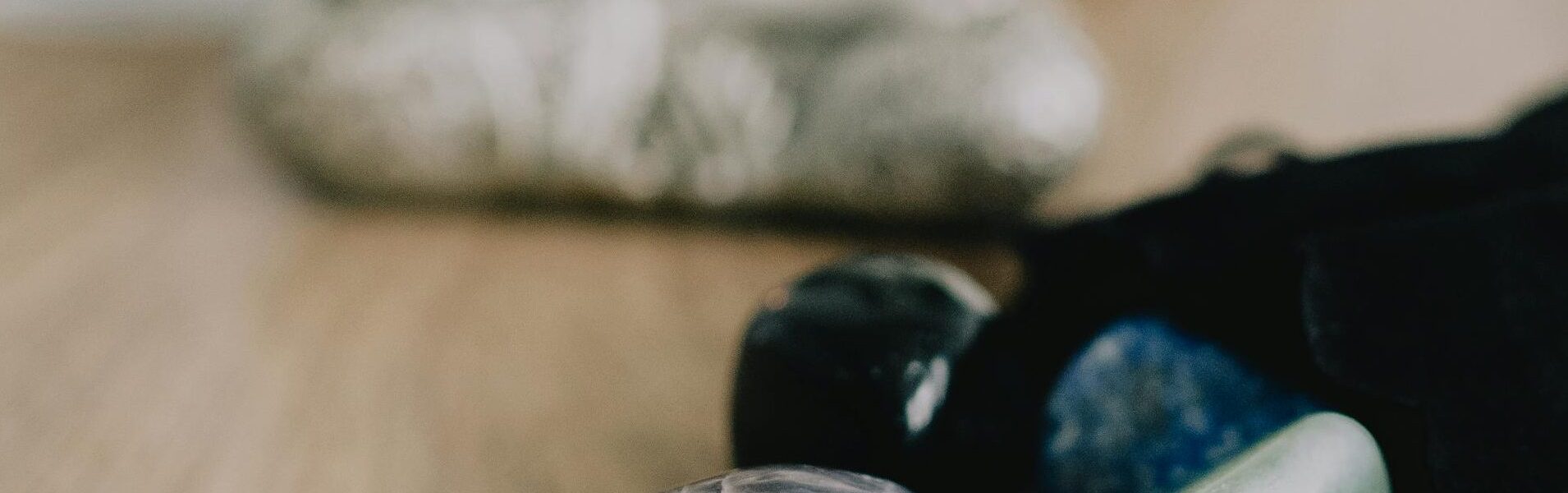 Serene Zen setup with healing crystals and a candle on a wooden table, promoting tranquility.