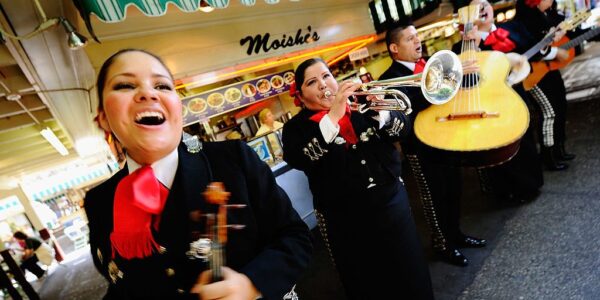 LOS ANGELES, CA - MAY 05:  Judith Merillo (L) Esmeralda Garcia (2nd-L) Guillermo Nunez (C) Mariana Nanez and Ileana Garcia (R)  members of the all-female strolling Mariachi band, Ellas Son, perform at Los Angeles Farmer Market during Cinco de Mayo festivities on May 5, 2011 in Los Angeles, California. Nunez was filling for the recovering injured female base player who was shot in the arm at a Mexican restaurant two weeks ago. Cinco de Mayo celebrates the 1862 Mexican victory over the French in the Battle of Puebla.  (Photo by Kevork Djansezian/Getty Images)