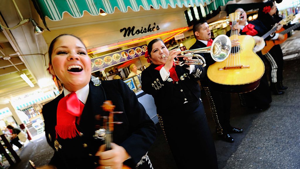 LOS ANGELES, CA - MAY 05:  Judith Merillo (L) Esmeralda Garcia (2nd-L) Guillermo Nunez (C) Mariana Nanez and Ileana Garcia (R)  members of the all-female strolling Mariachi band, Ellas Son, perform at Los Angeles Farmer Market during Cinco de Mayo festivities on May 5, 2011 in Los Angeles, California. Nunez was filling for the recovering injured female base player who was shot in the arm at a Mexican restaurant two weeks ago. Cinco de Mayo celebrates the 1862 Mexican victory over the French in the Battle of Puebla.  (Photo by Kevork Djansezian/Getty Images)