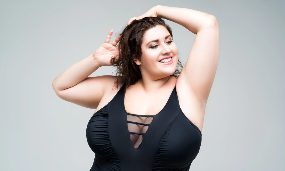Sexy plus size fashion model in black one piece swimsuit
