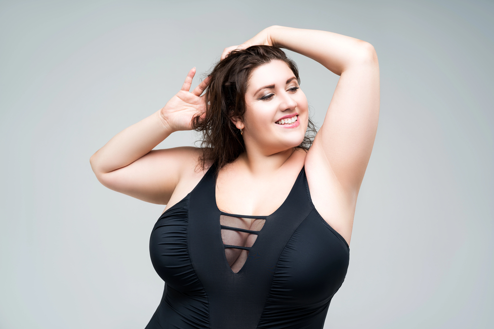 Sexy plus size fashion model in black one piece swimsuit