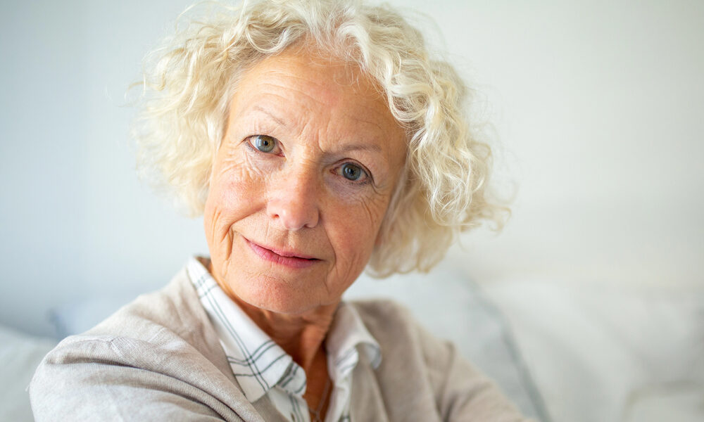 Close up portrait attractive elderly woman staring