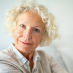 Close up portrait attractive elderly woman staring