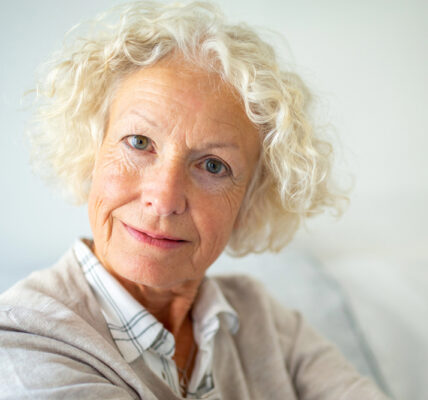 Close up portrait attractive elderly woman staring