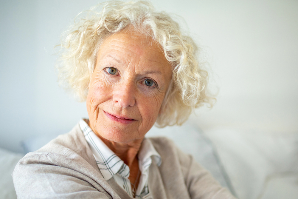 Close up portrait attractive elderly woman staring