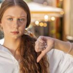 Disapproving teenager thumbs down. Image credit Andrii Iemelianenko via Shutterstock