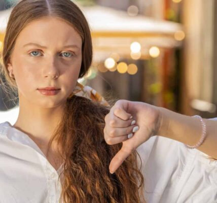 Disapproving teenager thumbs down. Image credit Andrii Iemelianenko via Shutterstock