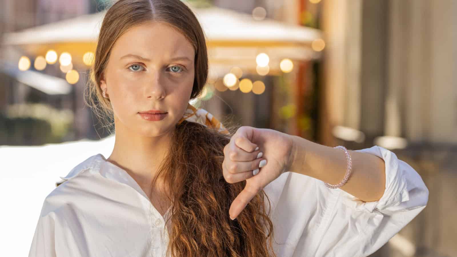 Disapproving teenager thumbs down. Image credit Andrii Iemelianenko via Shutterstock