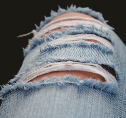 Detailed shot of torn denim jeans showcasing modern fashion and style.
