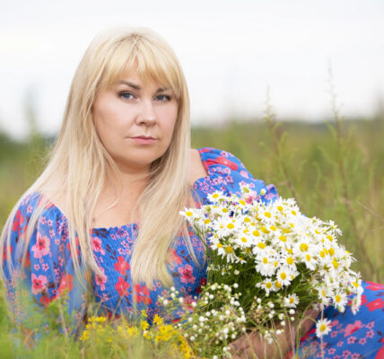 A beautiful plus size girl with white hair in a summer dress