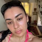 Charli XCX Wears a Plunging Lace Bra While Posing in Bed